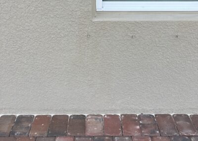 New stucco crack that started at the corner of the white vinyl window going town to the lanai pavers found during our Shield Home Watch Service Call in Lakewood Ranch and Manatee County!