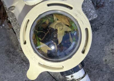 Pool skimmer visual port shows sticks, leaves, and other debris in the skimmer causing it to damage the pool pump was identified during our Shield Home Watch Service Call in Lakewood Ranch and Manatee County!