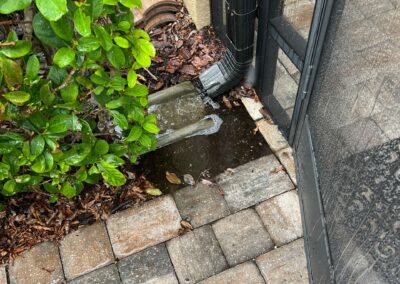 Lanai Erosion from Heavy Florida Rain pooling on the left side was pushing the pavers up causing the door to not open was identified during our Shield Home Watch Service Call