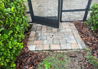 Lanai Erosion from Heavy Florida Rain pooling on the left side was pushing the pavers up causing the door to not open was identified during our Shield Home Watch Service Call